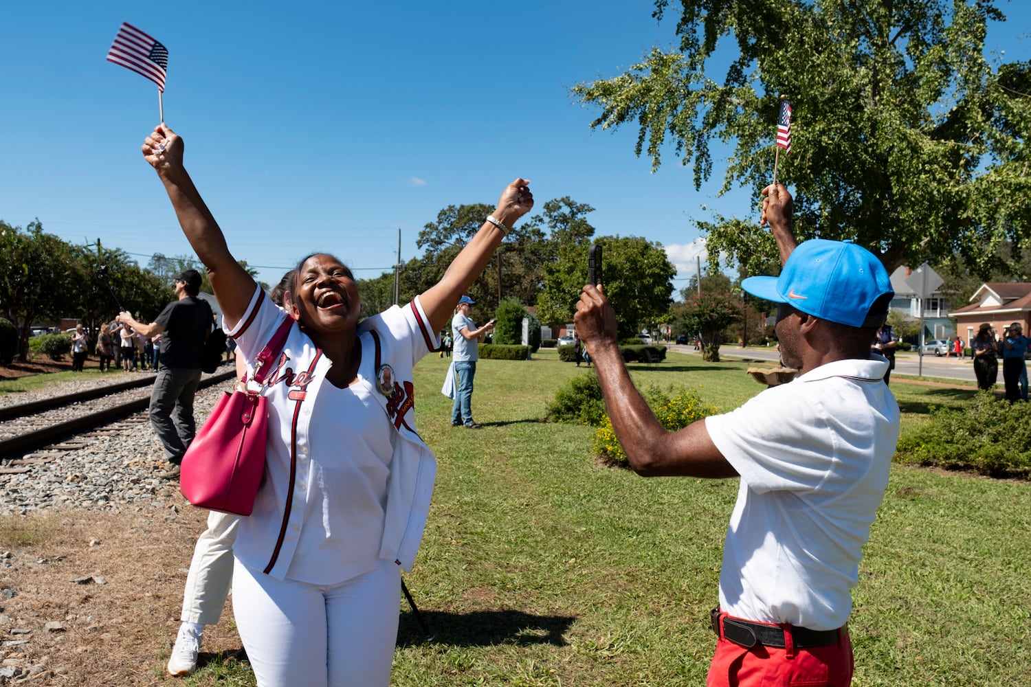 Sherrell and Derrell Dowdell of Americus cheer after singing a rendition of Happy Birthday for President Jimmy Carter’s 100th birthday in Plains on Tuesday, Oct. 1, 2024. Ben Gray for the Atlanta Journal-Constitution