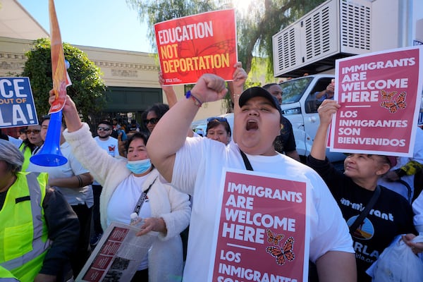 Immigrants join labor unions, faith organizations, and other immigrant rights and social justice organizations, including Coalition for Humane Immigrant Rights (CHIRLA) and National Day Laborer Organizing Network (NDLON), to mark "International Migrants Day" with a march and rally on Wednesday, Dec. 18, 2024, in Los Angeles. (AP Photo/Damian Dovarganes)