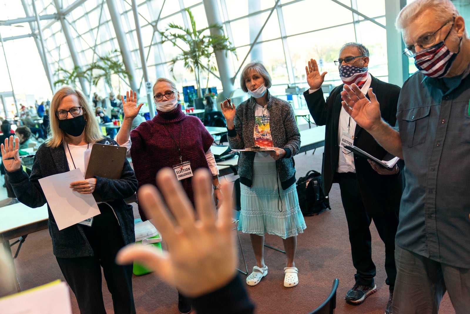 FILE - Election challengers are sworn in before observing the counting of ballots on Election Day at City Hall in Warren, Mich., Tuesday, Nov. 3, 2020. (AP Photo/David Goldman, File)