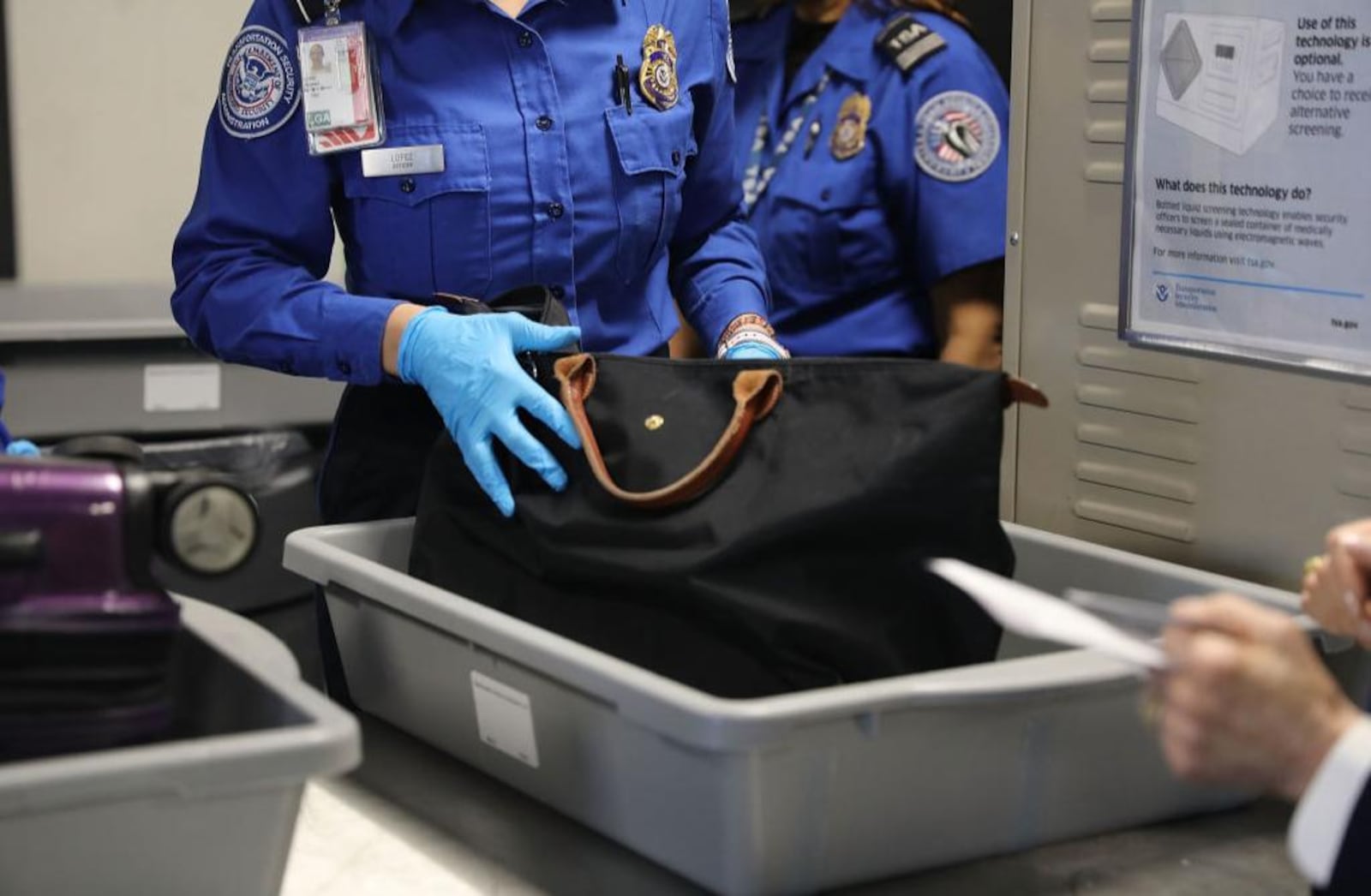 A Transportation Security Administration (TSA) worker screens luggage.