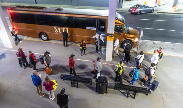 Arriving and departing riders began traveling by shuttle from Hartsfield-Jackson International Airport’s North domestic terminal on Monday April 8, 2024 after the MARTA rail station at the airport closed for six weeks for renovations requiring riders to transfer to a shuttle to get to arrive or depart from the airport on the transit service. MARTA officials have been preparing for months for the closure, setting up a shuttle bus bridge between the College Park MARTA station and the airport to maintain connectivity for travelers and workers, and notifying employers to prepare them for the disruption. Officials are recommending riders allow an extra half hour to get to Hartsfield-Jackson on MARTA. The shuttles appeared to be operating smoothly on the first day of the station closure. Brian Lane, who lives in Gainesville, took MARTA and the shuttle to the airport on Monday morning and said it was a smooth process. “I was a little anxious that it might be extra time but (it was) very smooth and didn’t really tackle much extra time to get here,” Lane said, adding that he was “very impressed.” The Airport station will be closed from April 8 until May 19. MARTA said shuttle buses will be in service from 4 a.m. until 2 a.m., and will drop off and pick up passengers at the domestic terminal North lower level, operating every 12 minutes. (Photo by John Spink/AJC)