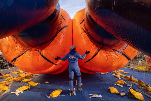 A person inflates a float of Goku in preparation for the Macy's Thanksgiving Day Parade, Wednesday, Nov. 27, 2024, in New York. (AP Photo/Yuki Iwamura)