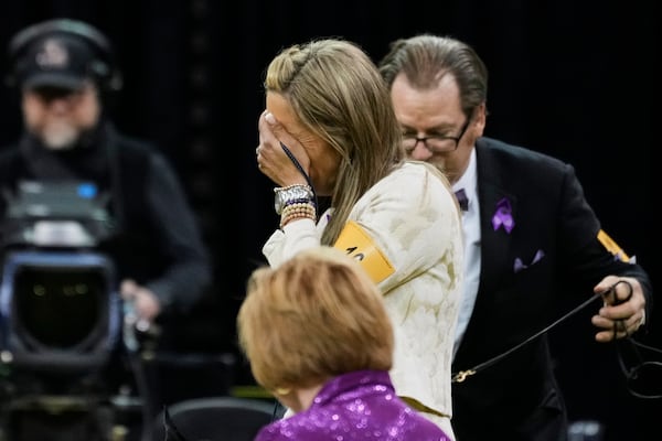 Katie Bernardin, center, reacts after winning best in show with Monty, a Giant Schnauzer, during the 149th Westminster Kennel Club Dog show, Tuesday, Feb. 11, 2025, in New York. (AP Photo/Julia Demaree Nikhinson)