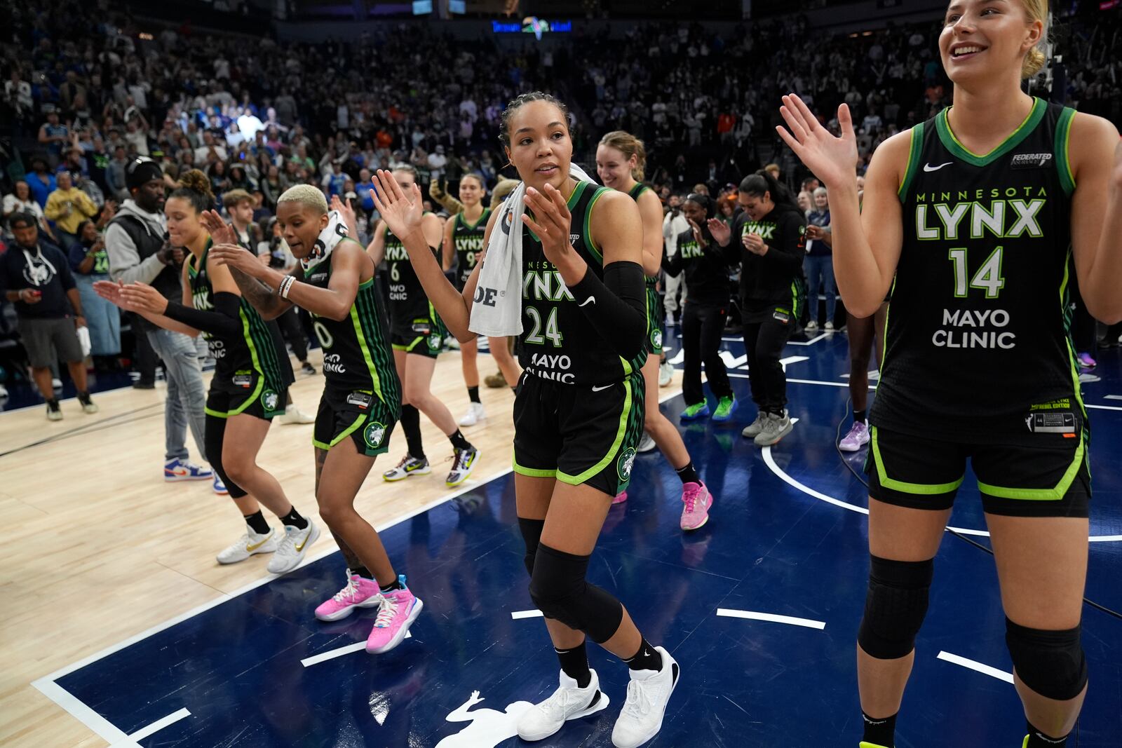 Minnesota Lynx forward Napheesa Collier (24) celebrates with teammates after the 88-77 win against the Connecticut Sun of Game 5 of a WNBA basketball semifinals, Tuesday, Oct. 8, 2024, in Minneapolis. (AP Photo/Abbie Parr)