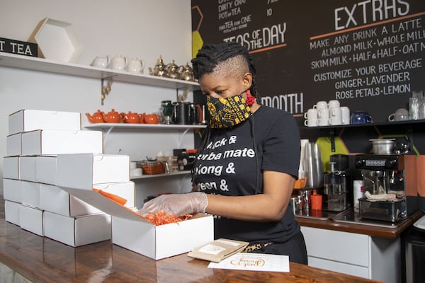 Just Add Honey Tea Company co-owner Brandi Shelton goes through an online order at the shop, located at 684 John Wesley Dobbs Avenue, in Atlanta's Old Fourth Ward neighborhood, Thursday, April 30, 2020. They have switched their focus to online orders during the COVID-19 pandemic. (ALYSSA POINTER / ALYSSA.POINTER@AJC.COM)