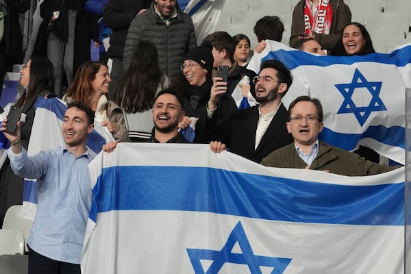 Israeli supporters display their national flag before the UEFA Nations League soccer match between France and Israel at the Stade de France stadium in Saint-Denis, outside Paris, Thursday Nov. 14, 2024. (AP Photo/Michel Euler)