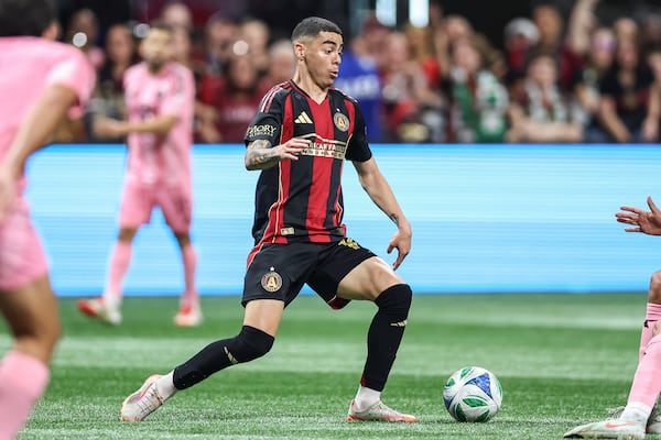 Atlanta United midfielder Miguel Almirón, center, looks to pass the ball during the second half of an MLS soccer match against Inter Miami, Sunday, March, 16, 2025, in Atlanta. (AP Photo/Colin Hubbard)