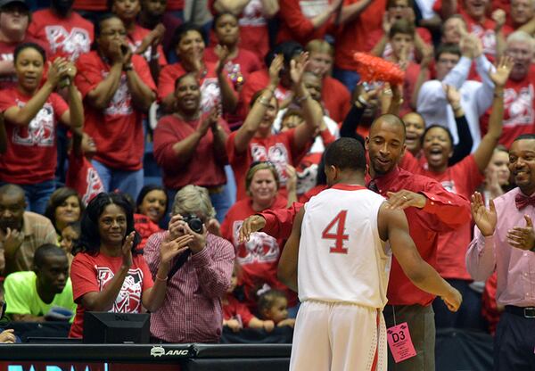 MARCH 8, 2014 MACON Morgan County Bulldogs head coach Charlemagne Gibbons embraces Bulldogs Tookie Brown #4 as he comes off the court late in the game. Brown led all scorers with 36 points. Coverage of the Class AAA boys basketball championship between the Buford Wolves and Morgan County Bulldogs at the Macon Coliseum Saturday, March 8, 2014. Morgan County won handily, beating the Buford Wolves 69-45. KENT D. JOHNSON / KDJOHNSON@AJC.COM Morgan County coach Charlemagne Gibbons embraces leading scorer Tookie Brown (4) as he comes off the court near the end of the Bulldogs' 69-45 win over Buford in the Class AAA boys title game Saturday, March 8, 2014, in Macon. (Kent D. Johnson / AJC)