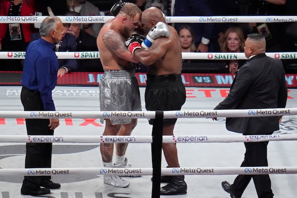 Jake Paul, left, and Mike Tyson embrace after their heavyweight boxing match, Friday, Nov. 15, 2024, in Arlington, Texas. (AP Photo/Julio Cortez)