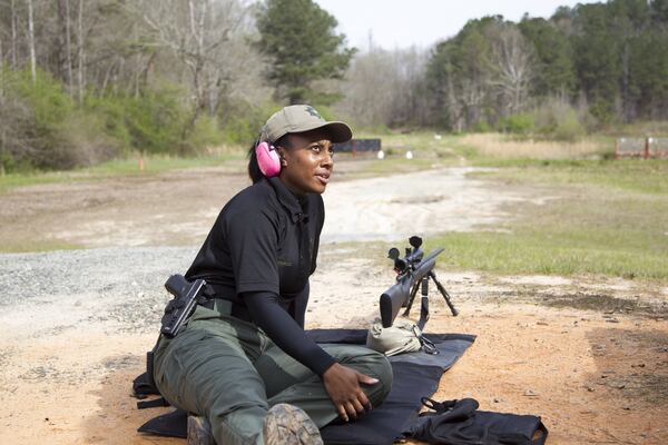 LaShira Norwood, 31, a Fulton County deputy, is shown with a Remington 700 sniper rifle at the David L. Hagins Firing Range in Atlanta, Georgia, on Monday, April 2, 2018. Norwood is Fulton County Sheriff Office’s first female sniper. (REANN HUBER/REANN.HUBER@AJC.COM)