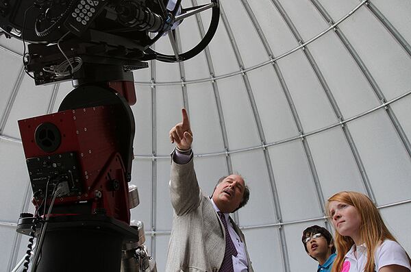 Tellus Science Museum astronomer David Dundee gives a tour of the observatory to Jerod Linares, 12, and Ashleigh Brown, 10, of Heirway Christian Academy.