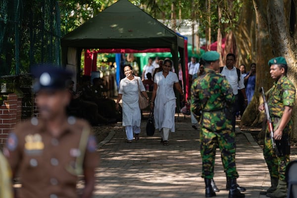 Workers leave a poll counting center following the parliamentary election in Colombo, Sri Lanka, Friday, Nov. 15, 2024. (AP Photo/Eranga Jayawardena)