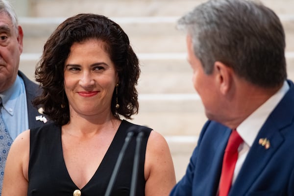 New Labor Commissioner Barbara Rivera Holmes smiles at Gov. Brian Kemp as he introduces her during a news conference at the Capitol in Atlanta on Tuesday.