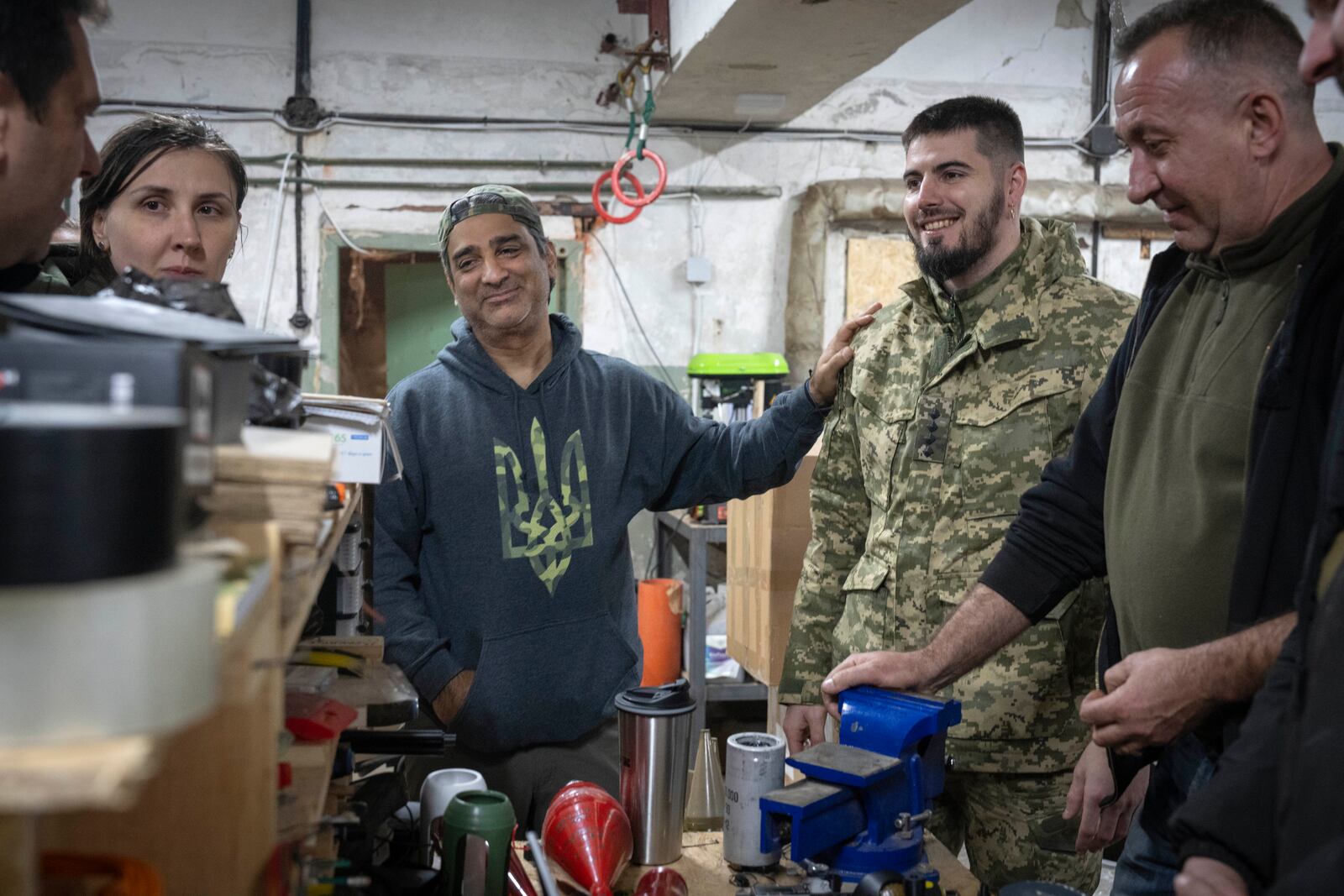 Amed Khan, a U.S. human rights advocate, political activist and philanthropist, center, listens to Yuri Fedorenko, commander of Ukraine's attack drones battalion "Achilles" in Kharkiv region, Ukraine, Sunday, Oct. 27, 2024. (AP Photo/Efrem Lukatsky)