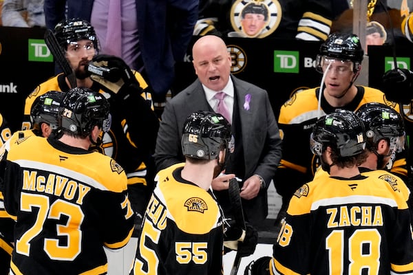 Boston Bruins head coach Jim Montgomery talks with his players during a time out during the third period of an NHL hockey game against the Philadelphia Flyers, Tuesday, Oct. 29, 2024, in Foxborough, Mass. (AP Photo/Charles Krupa)