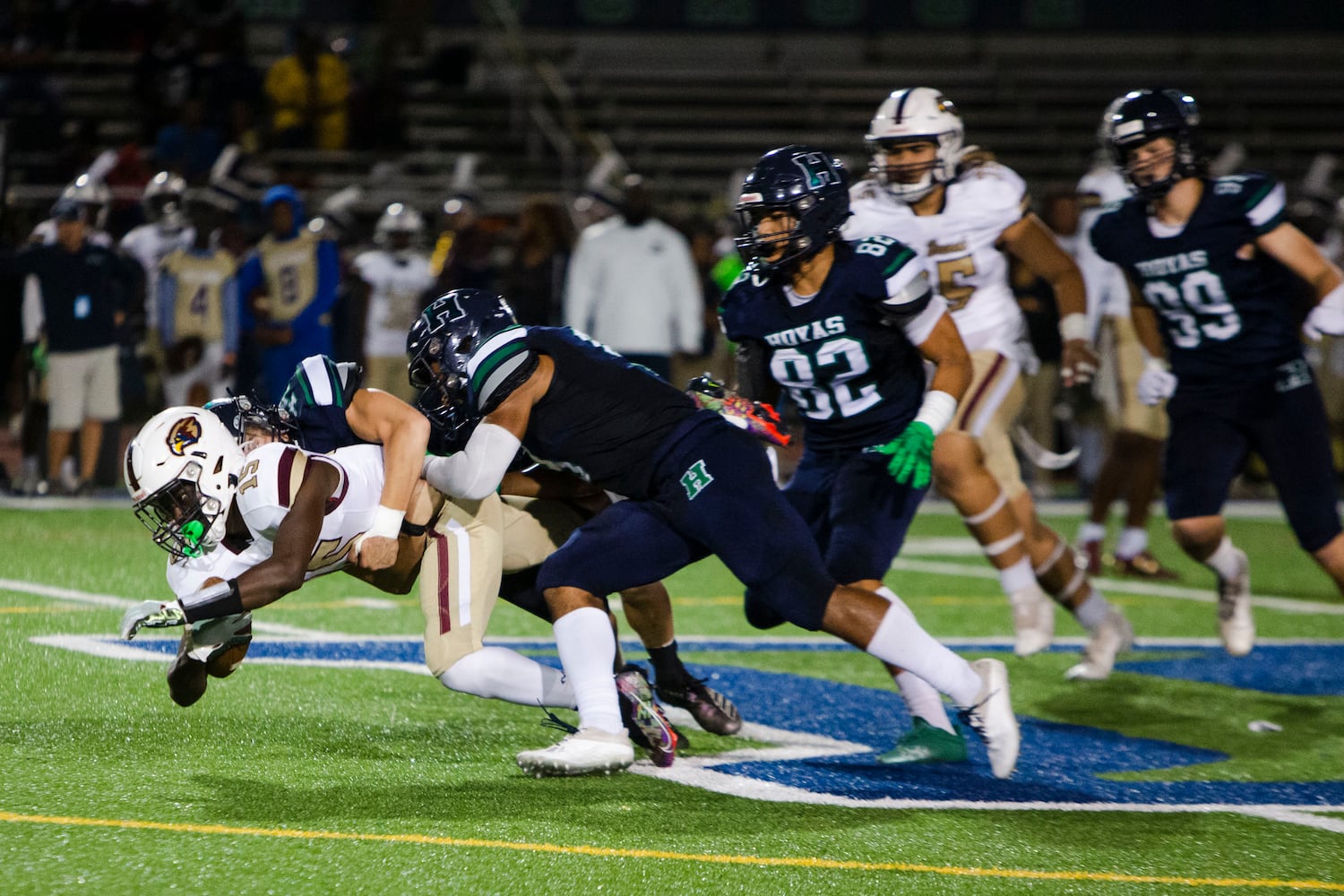 Members of the Harrison defense tackle Dylan Montoya, running back for Pebblebrook, during the Harrison vs. Pebblebrook high school football game on Friday, September 23, 2022, at Harrison high school in Kennesaw, Georgia. Pebblebrook defeated Harrison 31-14. CHRISTINA MATACOTTA FOR THE ATLANTA JOURNAL-CONSTITUTION.