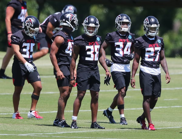 Falcons rookie cornerbacks and safeties Avery Williams (from left), JR Pace, Marcus Murphy, Darren Hall, and Richie Grant line up to run a defensive drill during rookie minicamp on Friday, May 14, 2021, in Flowery Branch. (Curtis Compton / Curtis.Compton@ajc.com)