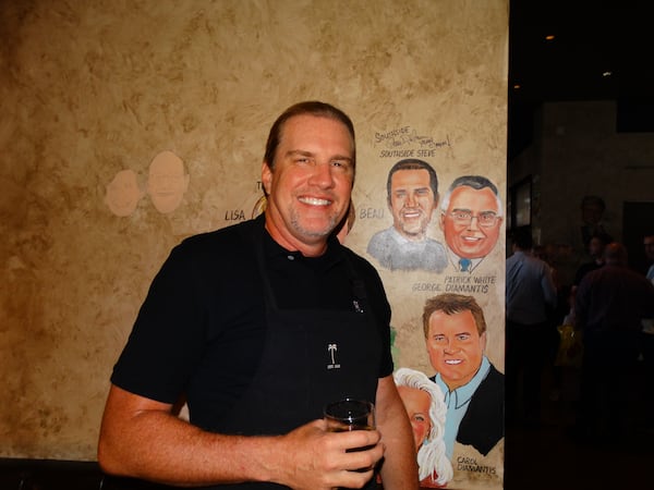 "Southside" Steve Rickman in 2016 at Bones gets a caricature, but he noticed immediately that his ponytail is not included. They plan to add one. "It's my signature," he said. CREDIT: Rodney Ho/rho@ajc.com