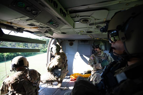 Ryan O'Hara (center) looks out of a U.S. Army helicopter during a training exercise. O'Hara was a Parkview High School graduate.