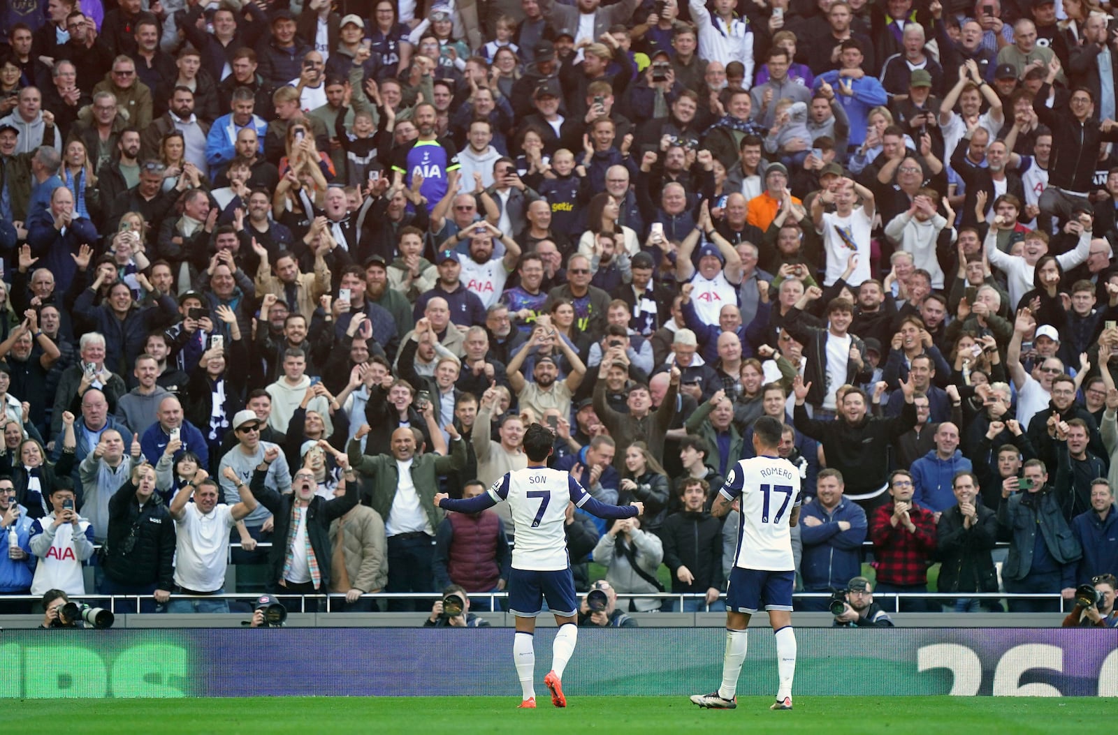 Tottenham Hotspur's Son Heung-Min, left, celebrates scoring with fans during the English Premier League soccer match between Tottenham Hotspur and West Ham United at the Tottenham Hotspur Stadium, London, Saturday Oct. 19, 2024. (Zac Goodwin/PA via AP)