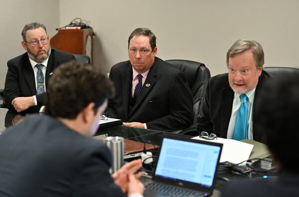 Two of three former Savannah soldiers Mark Jones, left, and Kenneth Gardiner, second from left, who were convicted of murder in 1992 and later had their convictions overturned, listen as Dr. Lester Plumly Jr. (right) speaks during a hearing at the Office of Georgia Secretary of State in Atlanta on Wednesday, February 5, 2020. HYOSUB SHIN / HYOSUB.SHIN@AJC.COM