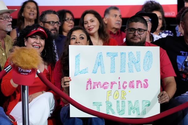 FILE - Supporters hold a sign before Republican presidential nominee former President Donald Trump arrives to speak during a campaign event, Sept.12, 2024, in Tucson, Ariz. (AP Photo/Alex Brandon, File)