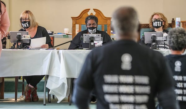 From left, poll workers Beth Claimo, Teresa Johnson and Karin Mueller wear masks and wait on voters to approach their table at Butler Street Baptist Church at 315 Ralph McGill Boulevard NE in Atlanta, Georgia on Tuesday, Nov. 3, 2020. (John Spink/Atlanta Journal-Constitution/TNS)