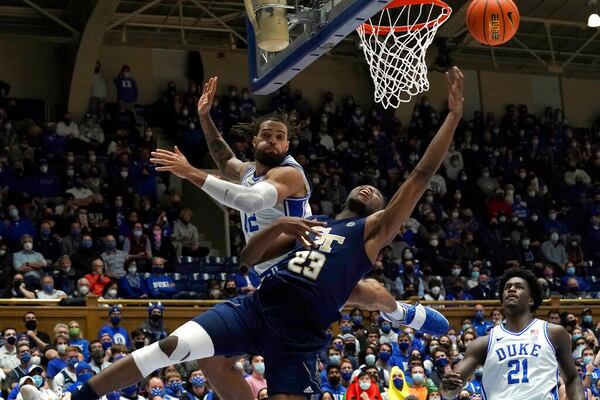 Georgia Tech forward Jordan Meka (23) drives under the basket while Duke forward Theo John (12) defends during the first half of an NCAA college basketball game in Durham, N.C., Tuesday, Jan. 4, 2022. (AP Photo/Gerry Broome)