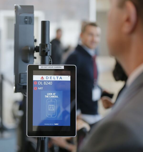 Travelers are cleared for boarding after clearing the facial recognition system. BOB ANDRES / BANDRES@AJC.COM