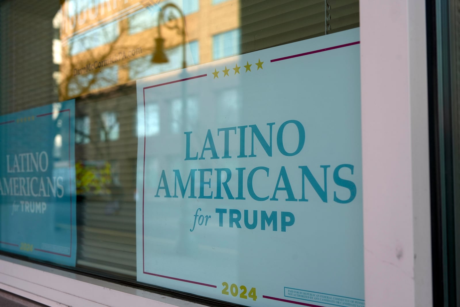 A sign is displayed at an office near the arena where Donald Trump held a rally in Reading, Pa., Monday, Nov. 4, 2024. (AP Photo/Luis Andres Henao)