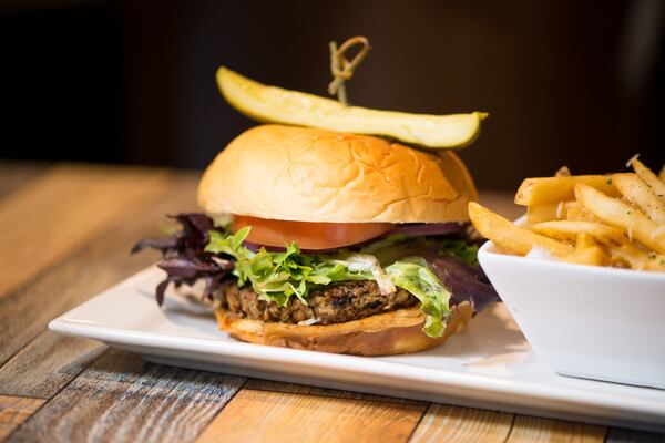 Gocha's Impossible Burger with Parmesan Truffle Fries on brioche bun with tomato, mixed greens, onion, and house aioli sauce. Photo credit- Mia Yakel.