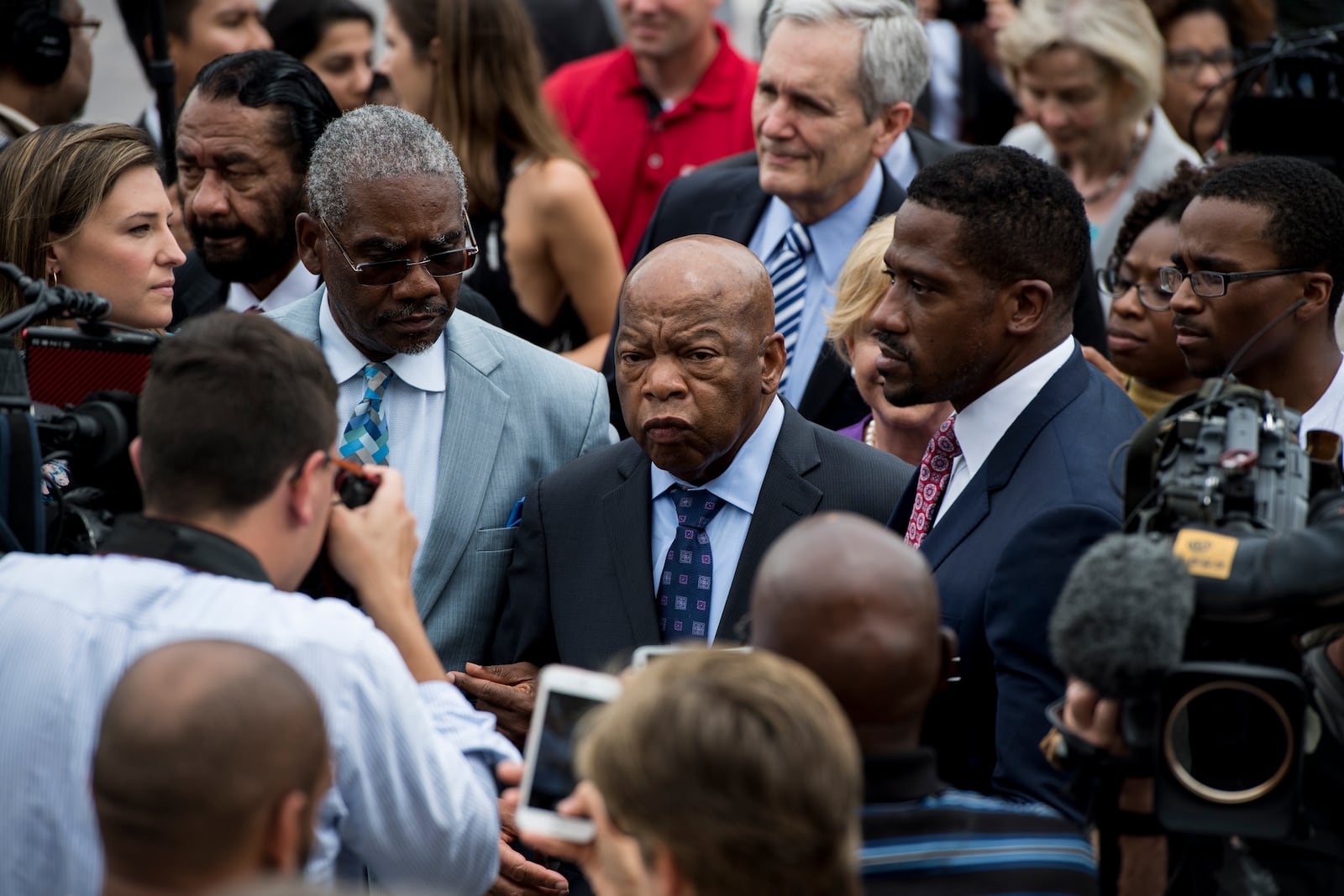 UNITED STATES - JUNE 23: Rep. John Lewis, D-Ga., right, and Rep. Gregory Meeks, D-N.Y., left, wade through the crowd of demonstrators on the East Plaza of the Capitol supporting the Democrats' sit-in for gun control legislation on Thursday, June 23, 2016. Rep. Lewis brought the sit-in to an end at 1 p.m., Thursday, thanking members for the 25-hour siege. (Photo By Bill Clark/CQ Roll Call)
 (CQ Roll Call via AP Images)