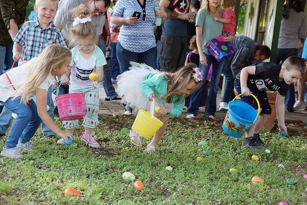 The age 5 and younger group runs to pick up eggs in their section of the park.