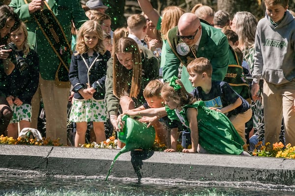 Members of the 2025 St. Patrick’s Day Parade Committee pour green dye into the fountain in Forsyth Park on March 7, 2025 in Savannah, GA. The dying of the fountain marks the beginning of the city’s St. Patrick’s Day festivities. (Justin Taylor/The Atlanta Journal Constitution)