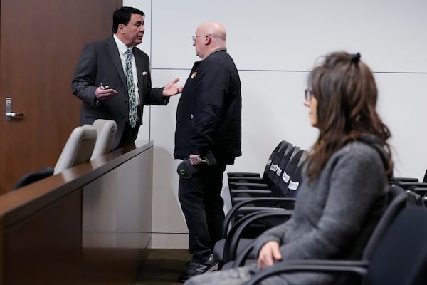 Robert E. Crimo III's attorney Gregory Ticsay, left, talks with Robert E. Crimo III's father Robert Crimo Jr., center, as Robert E. Crimo III's mother Denise Pesina looks on before Judge Victoria A. Rossetti during the jury selection for the trial of Robert E. Crimo III., at the Lake County Courthouse, Waukegan, Ill., Monday, Feb. 24, 2025. (AP Photo/Nam Y. Huh, Pool)