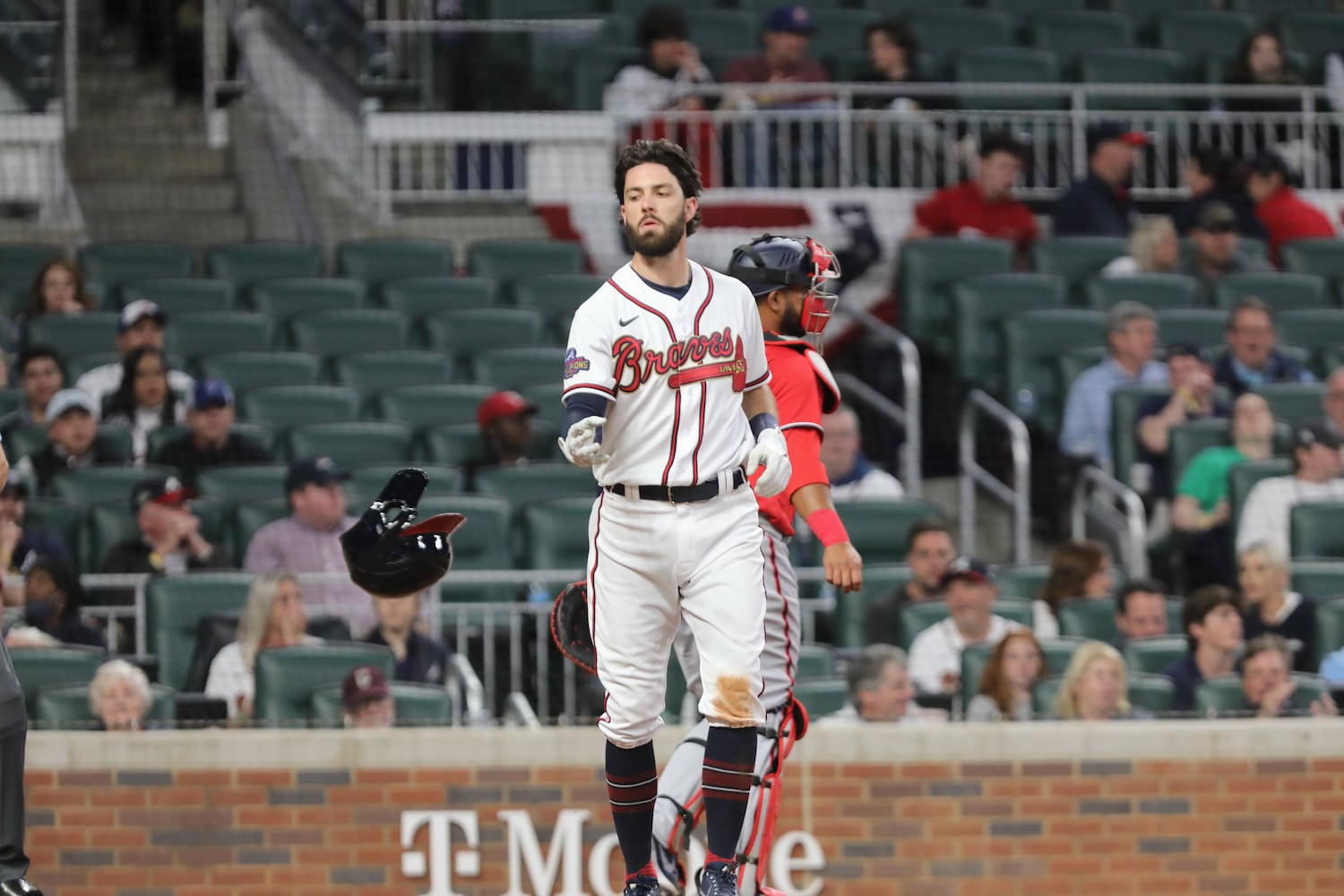 Braves shortstop Dansby Swanson tosses his helmet after striking out Monday night at Truist Park. (Miguel Martinez/miguel.martinezjimenez@ajc.com)