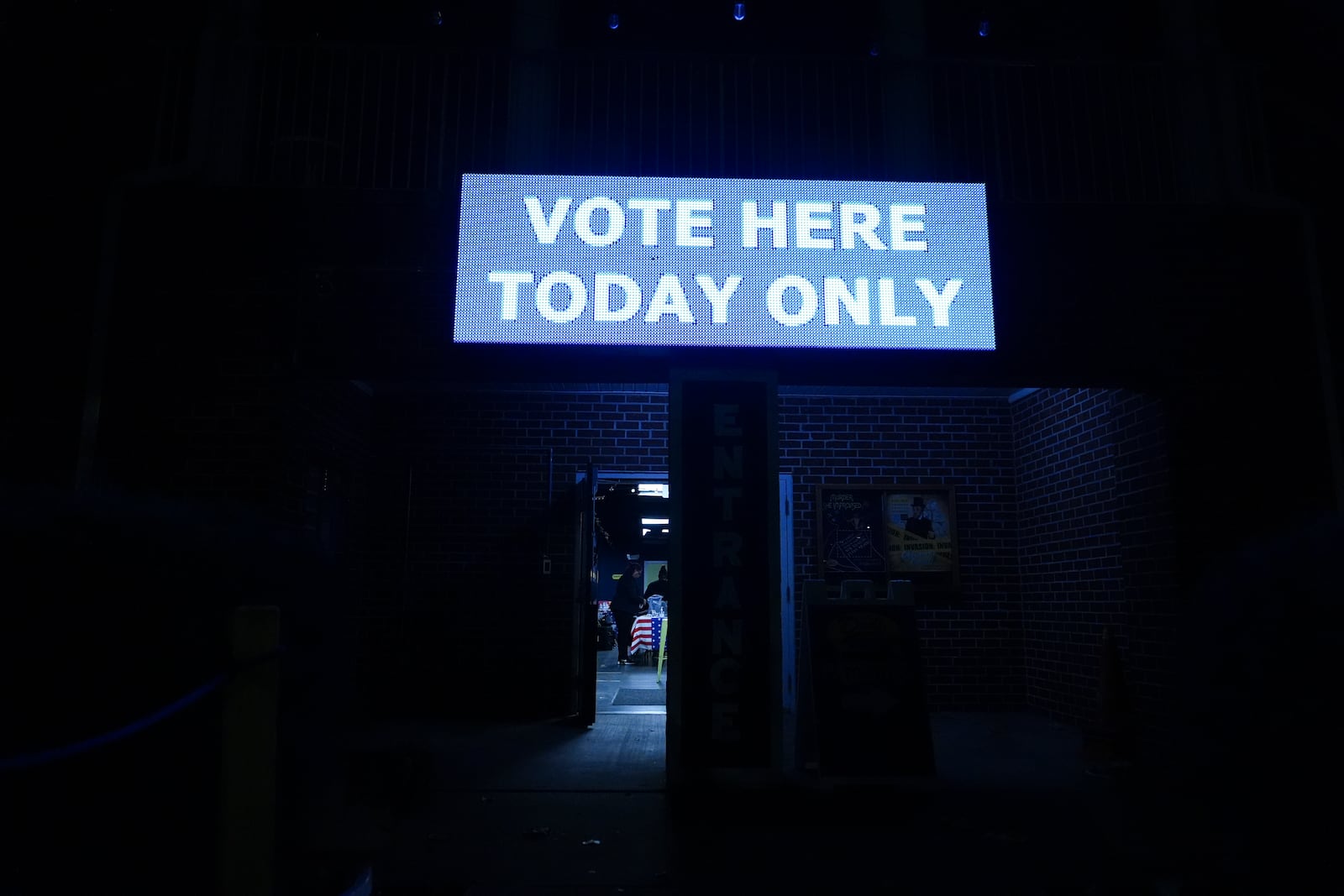 A poll worker sets up before a polling place opens, Tuesday, Nov. 5, 2024, in Atlanta.(AP Photo/Brynn Anderson)