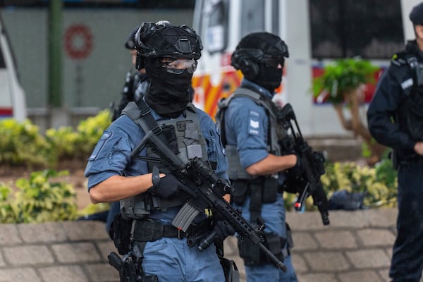 Armed police stand guard outside the West Kowloon Magistrates' Courts in Hong Kong, Wednesday, Nov. 20, 2024. (AP Photo/Chan Long Hei)