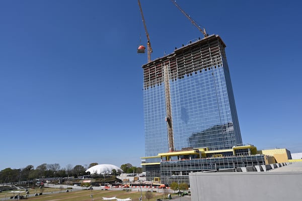 A gigantic peach is lifted up to the top during topping out ceremony of Signia by Hilton Atlanta at Georgia World Congress Center, Thursday, March 23, 2023, in Atlanta. Plans are in motion for GWCCA’s new headquarter hotel Signia by Hilton Atlanta. Featuring close to 1,000 rooms, this premier full-service hotel will sit on the northwest corner of the campus, adjacent to Building C of Georgia World Congress Center. (Hyosub Shin / Hyosub.Shin@ajc.com)