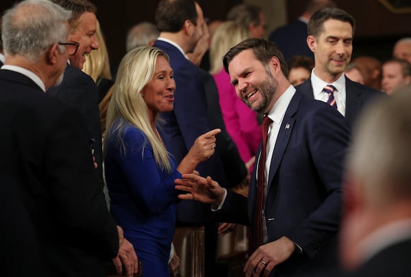 Vice President JD Vance, right, talks to Rep. Marjorie Taylor Greene, R-Ga., before President Donald Trump addresses a joint session of Congress at the Capitol in Washington, Tuesday, March 4, 2025. (Win McNamee/Pool Photo via AP)