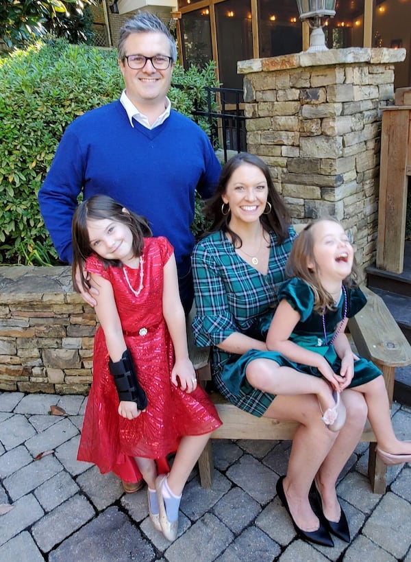 Denice Dudley and husband Phillip Dudley and their daughters Marian (red dress) who is 7, and Evelyn (green dress) who is 4. (Submitted photo)