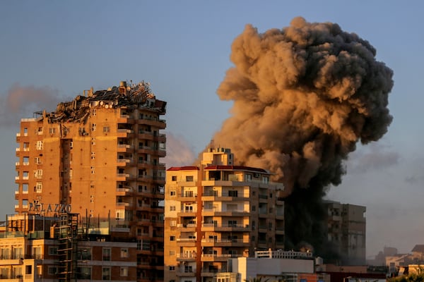 Smoke rises from a building hit in an Israeli airstrike in Tyre, southern Lebanon, Saturday, Nov. 16, 2024. (AP Photo/Mohammed Zaatari)