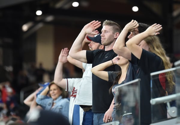 Braves fans do the "tomahawk chop" during Friday's game.  (Hyosub Shin / Hyosub.Shin@ajc.com)