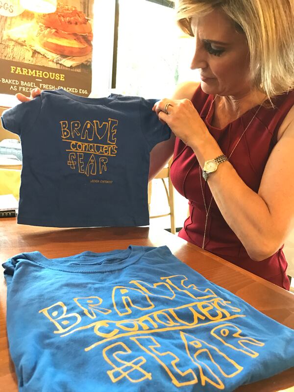  Cheryl Preheim shows off the T-shirts inspired by her son Joshua. CREDIT: Rodney Ho/rho@ajc.com