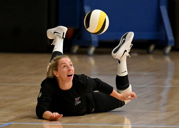 The Atlanta Vibe's Morgan Hentz slides to return the ball during practice. AJC file photo