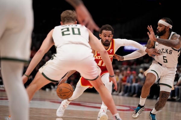 Atlanta Hawks guard Trae Young (11) dribbles the ball in the first half of an NBA basketball game against the Milwaukee Bucks, Tuesday, March 4, 2025, in Atlanta. (AP Photo/Brynn Anderson)