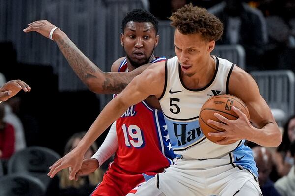 Atlanta Hawks guard Dyson Daniels (5) drives against Philadelphia 76ers forward Justin Edwards (19) during the first half of an NBA basketball game, Sunday, March 23, 2025, in Atlanta. (AP Photo/Mike Stewart)