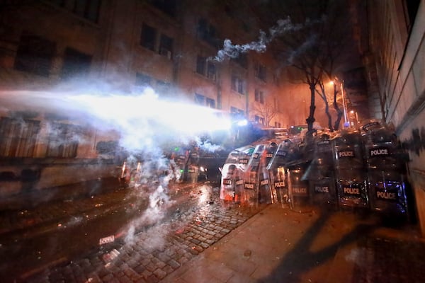 Police use a water cannon to block protesters during a rally against the governments' decision to suspend negotiations on joining the European Union for four years, outside the parliament's building in Tbilisi, Georgia, on Sunday, Dec. 1, 2024. (AP Photo/Zurab Tsertsvadze)