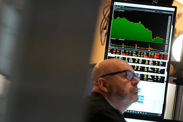 People work on the floor at the New York Stock Exchange in New York, Monday, Feb. 24, 2025. (AP Photo/Seth Wenig)