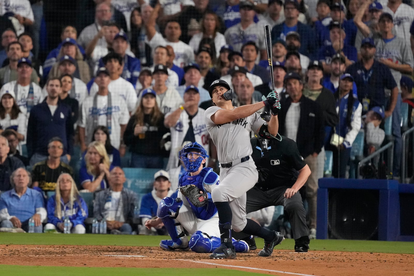 New York Yankees' Giancarlo Stanton watches his two-run home during the sixth inning in Game 1 of the baseball World Series against the Los Angeles Dodgers, Friday, Oct. 25, 2024, in Los Angeles. (AP Photo/Mark J. Terrill)